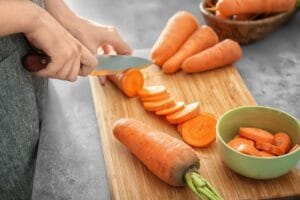 A young women cutting carrot for salad