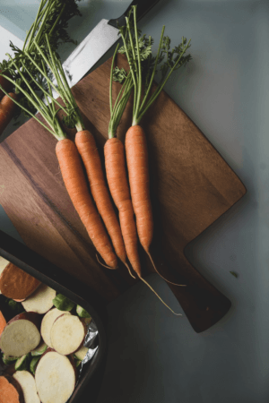 Fresh carrots ready to be cut for a nutritious salad.