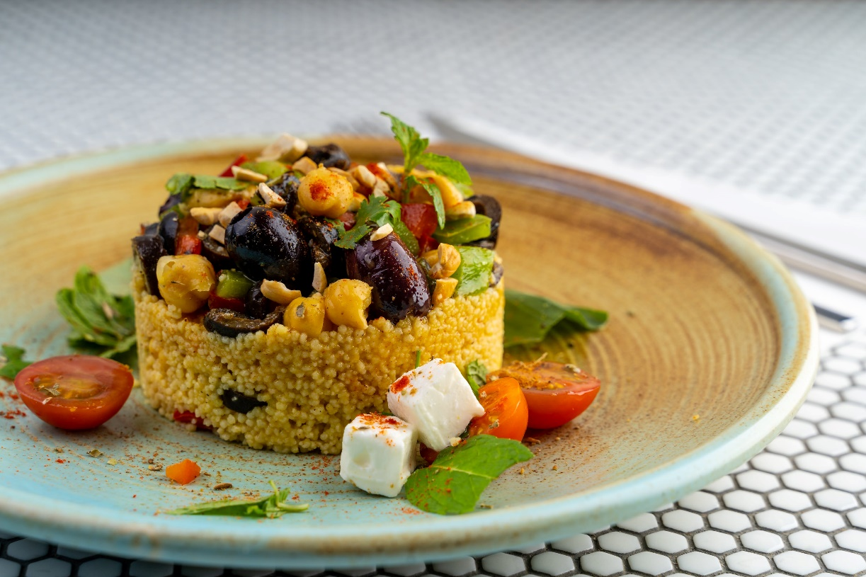 A plate of couscous with salad 